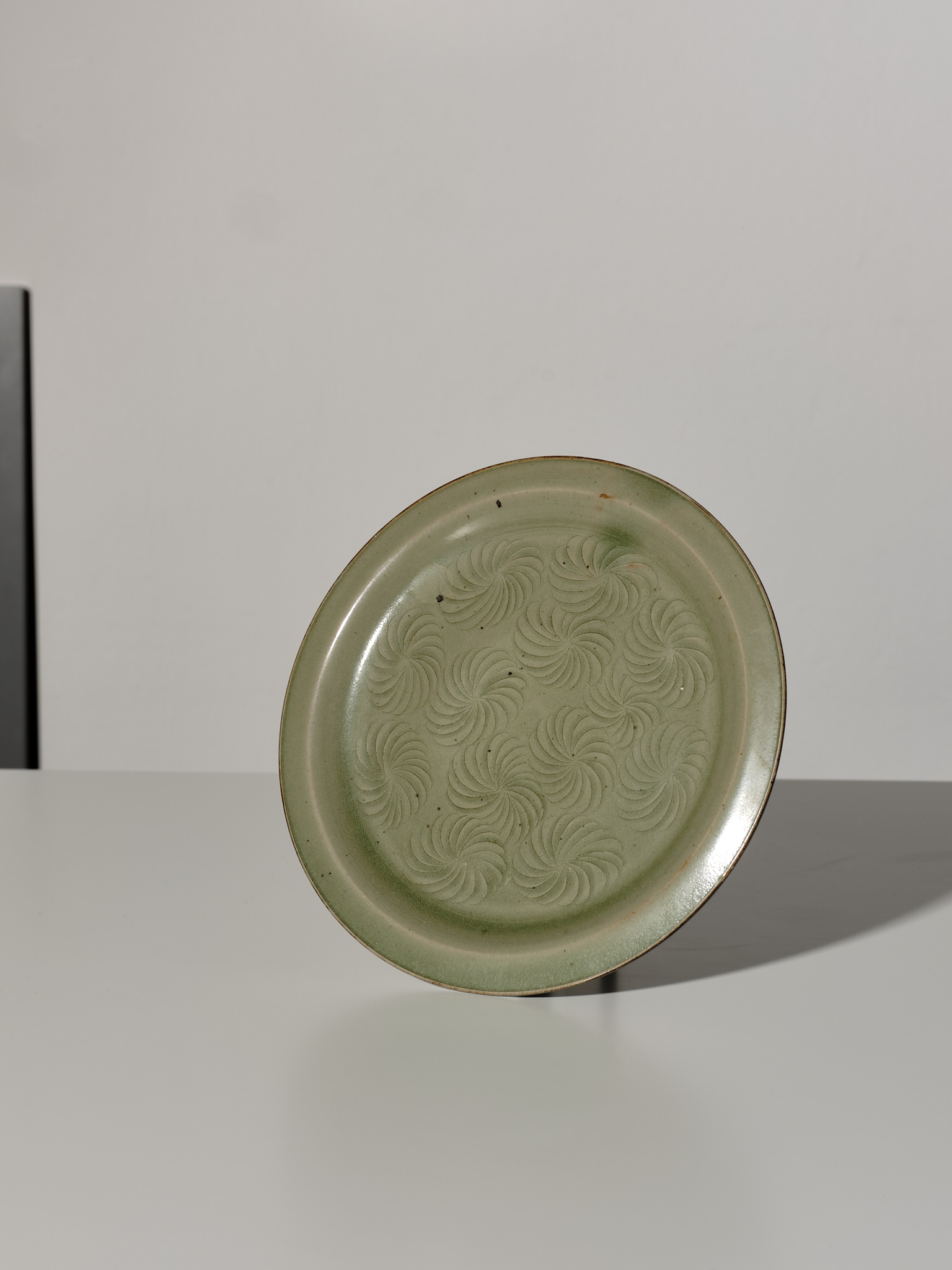 Lot 371 - A YAOZHOU CELADON CARVED DISH, SONG DYNASTY