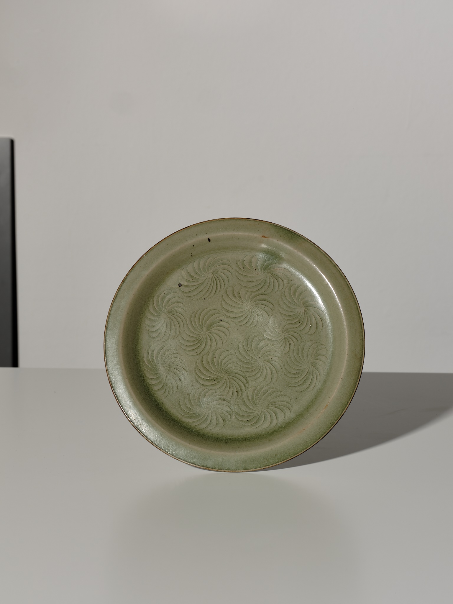 Lot 371 - A YAOZHOU CELADON CARVED DISH, SONG DYNASTY