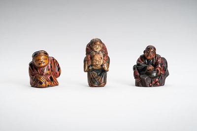 Lot 1565 - A LOT WITH THREE FIGURAL LACQUERED WOOD NETSUKE