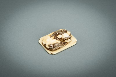 Lot 312 - A RENSAI STYLE IVORY NETSUKE OF A SHISHI, MEIJI