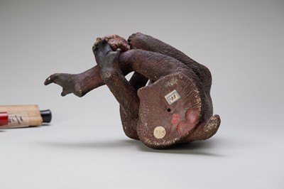 Lot 256 - A RARE AND LARGE PAINTED POTTERY OKIMONO OF A MONKEY EXAMINING A MONKEY NETSUKE