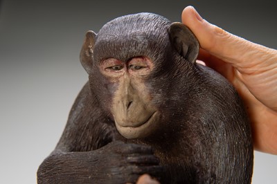Lot 256 - A RARE AND LARGE PAINTED POTTERY OKIMONO OF A MONKEY EXAMINING A MONKEY NETSUKE