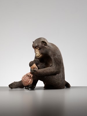 Lot 256 - A RARE AND LARGE PAINTED POTTERY OKIMONO OF A MONKEY EXAMINING A MONKEY NETSUKE