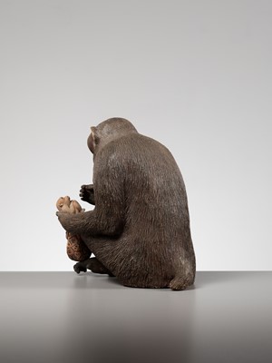 Lot 256 - A RARE AND LARGE PAINTED POTTERY OKIMONO OF A MONKEY EXAMINING A MONKEY NETSUKE