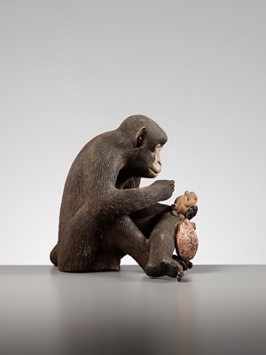 Lot 256 - A RARE AND LARGE PAINTED POTTERY OKIMONO OF A MONKEY EXAMINING A MONKEY NETSUKE