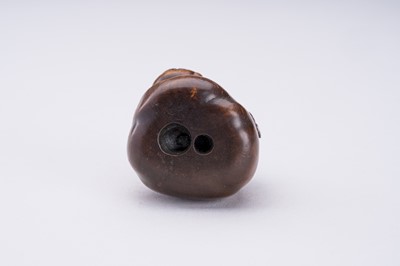 Lot 372 - A WOOD NETSUKE OF HOTEI AND A BOY INSIDE HIS TREASURE BAG