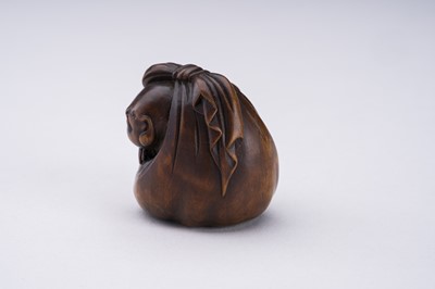 Lot 372 - A WOOD NETSUKE OF HOTEI AND A BOY INSIDE HIS TREASURE BAG