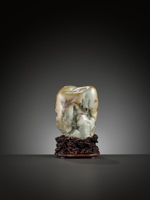 Lot 39 - A CELADON AND RUSSET JADE ‘LUOHAN IN A GROTTO’ BOULDER, 17TH - 18TH CENTURY