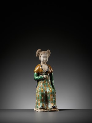 Lot 1192 - A RARE SANCAI-GLAZED POTTERY FIGURE OF A SEATED COURT LADY, TANG DYNASTY OR LATER