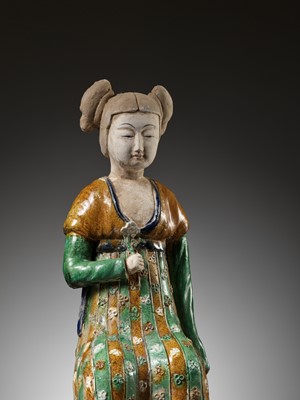 Lot 1192 - A RARE SANCAI-GLAZED POTTERY FIGURE OF A SEATED COURT LADY, TANG DYNASTY OR LATER