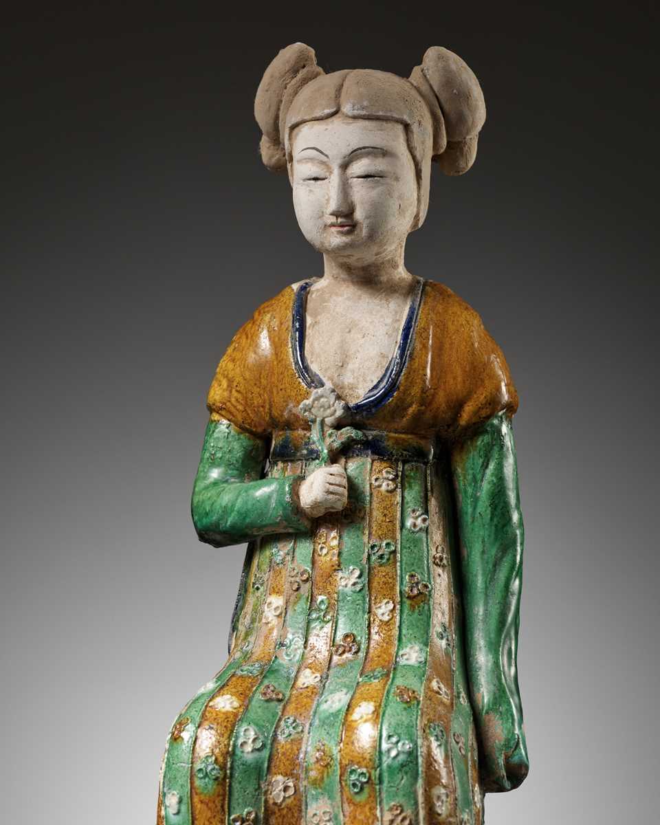 Lot 1192 - A RARE SANCAI-GLAZED POTTERY FIGURE OF A SEATED COURT LADY, TANG DYNASTY OR LATER
