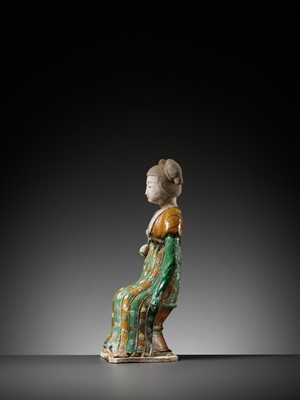 Lot 1192 - A RARE SANCAI-GLAZED POTTERY FIGURE OF A SEATED COURT LADY, TANG DYNASTY OR LATER