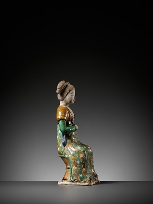 Lot 1192 - A RARE SANCAI-GLAZED POTTERY FIGURE OF A SEATED COURT LADY, TANG DYNASTY OR LATER