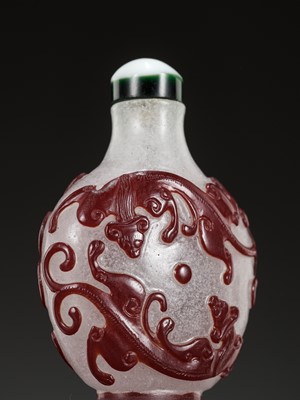 Lot 594 - A RUBY-RED OVERLAY SNOWFLAKE GLASS ‘CHILONG’ SNUFF BOTTLE, 19TH CENTURY