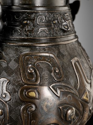 Lot 137 - A GOLD AND SILVER-INLAID BRONZE ARCHAISTIC WINE VESSEL, YOU, 17TH-18TH CENTURY