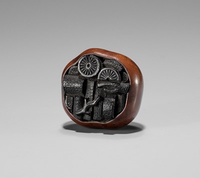 Lot 616 - A BOXWOOD AND EBONY NETSUKE OF A BASKET OF CHARCOAL