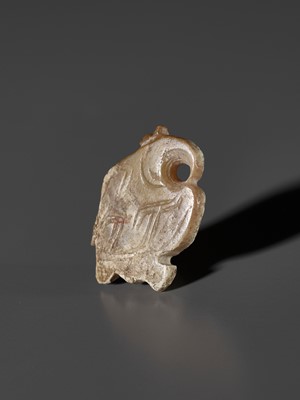 Lot 1025 - A PALE CELADON AND RUSSET JADE ‘BIRD’ PENDANT, LATE SHANG DYNASTY
