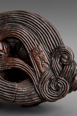 Lot 307 - MASATOMO: A BOXWOOD NETSUKE OF A SHISHI LION, EDO PERIOD