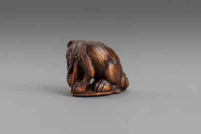 Lot 307 - MASATOMO: A BOXWOOD NETSUKE OF A SHISHI LION, EDO PERIOD