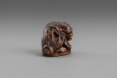 Lot 307 - MASATOMO: A BOXWOOD NETSUKE OF A SHISHI LION, EDO PERIOD