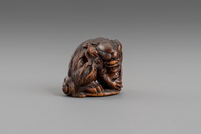 Lot 307 - MASATOMO: A BOXWOOD NETSUKE OF A SHISHI LION, EDO PERIOD