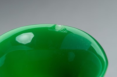AN APPLE GREEN GLASS CUP AND SAUCER