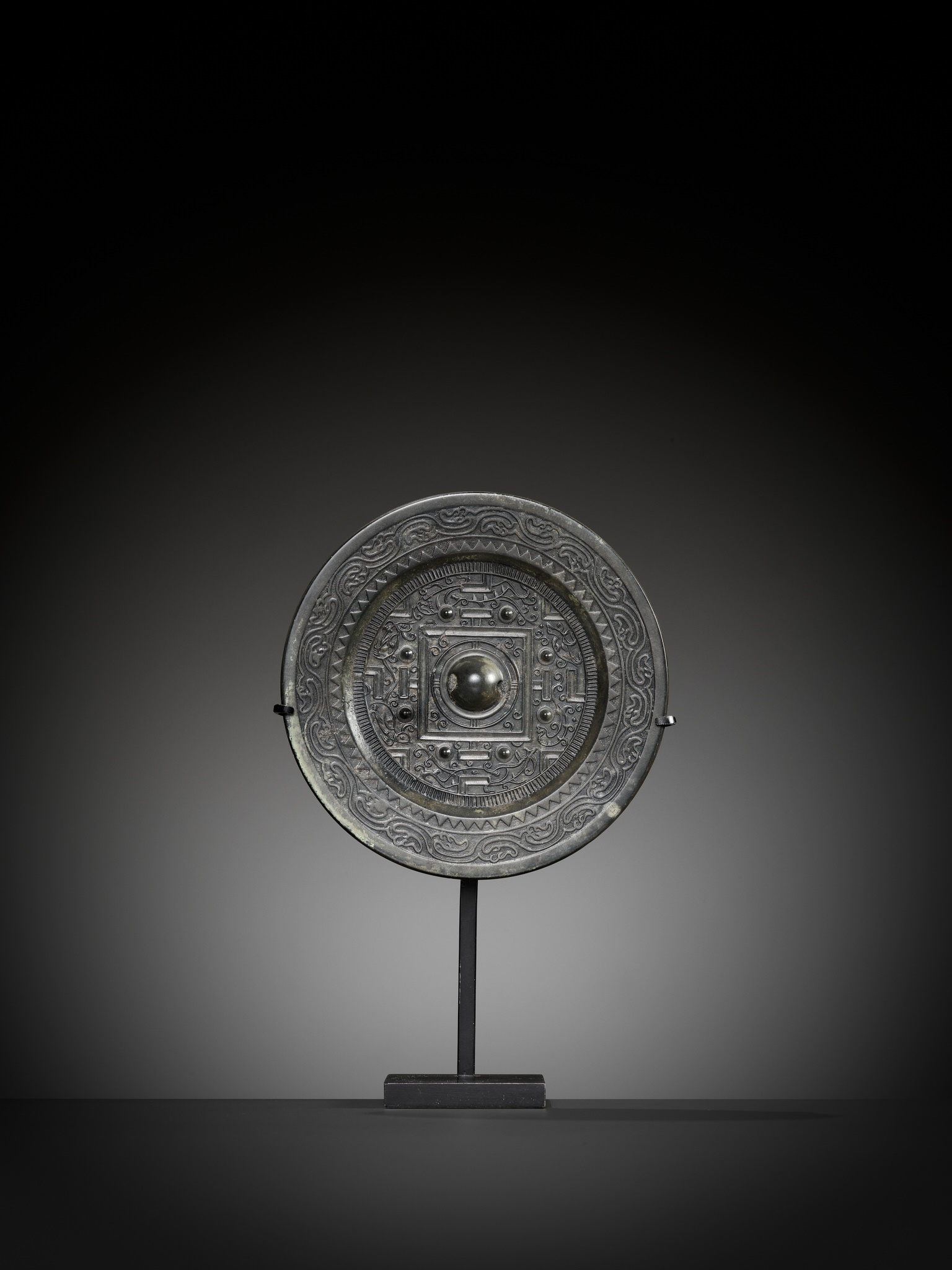 A SILVERY BRONZE 'TLV' MIRROR, HAN DYNASTY 漢代鎏銀銅鏡