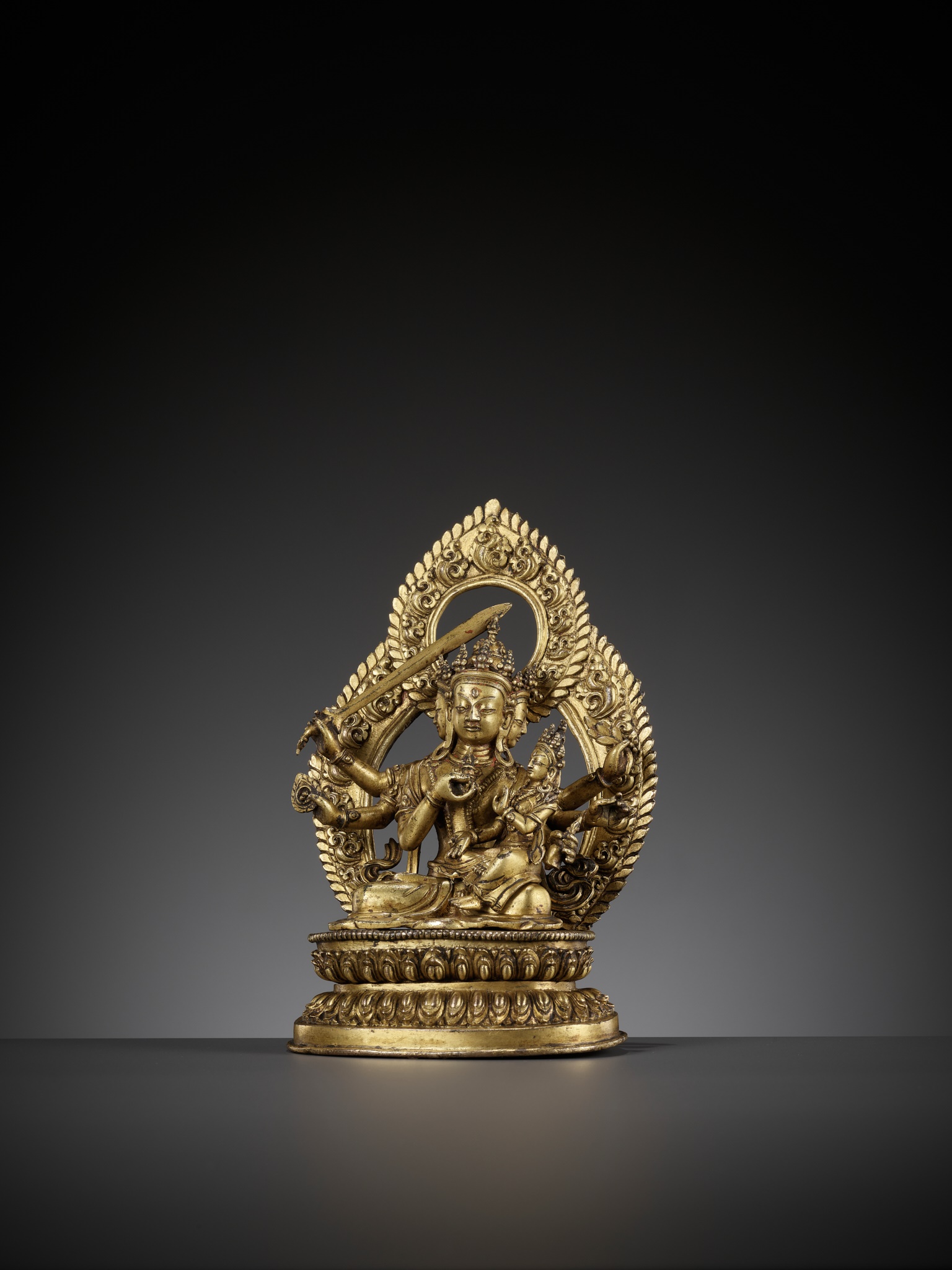 Lot 181 - A GILT BRONZE FIGURE OF SADBHUJA MANJUSRI,