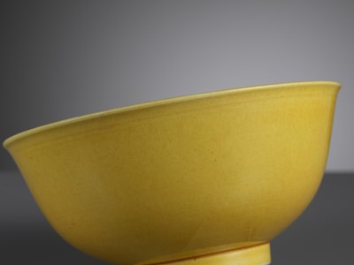 Lot 124 - A NEAR PAIR OF IMPERIAL YELLOW-GLAZED BOWLS, DAOGUANG MARKS AND PERIOD