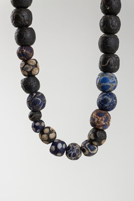 Lot 1652 - A SUMERIAN GLASS BEAD NECKLACE, c. 2000 BC