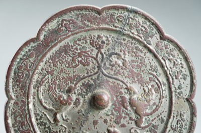 Lot 142 - A LARGE EIGHT-LOBED BRONZE ‘PHOENIX AND LION’ MIRROR, TANG