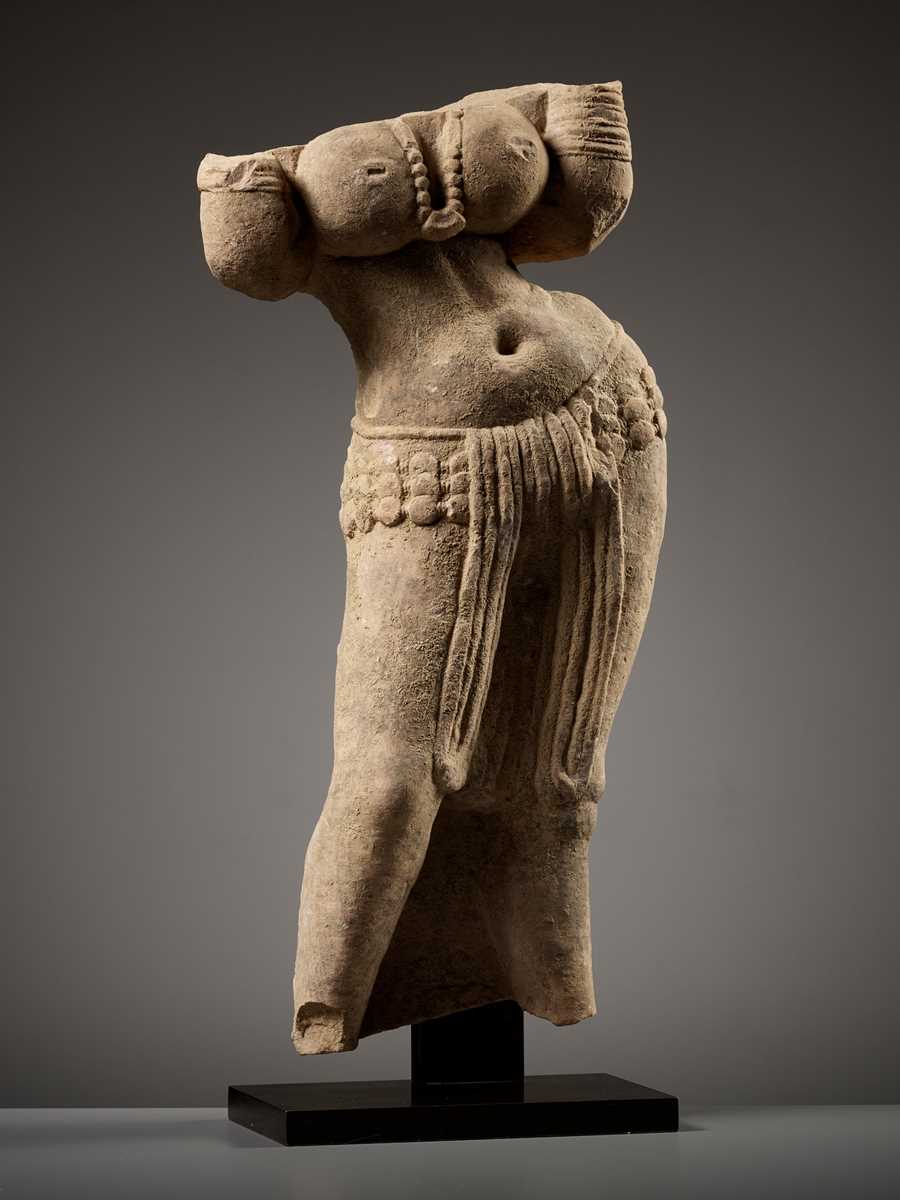 Lot 187 A SANDSTONE TORSO OF A YAKSHI INDIA