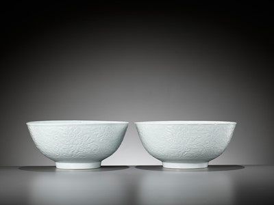 Lot 403 - A PAIR OF LARGE CARVED PALE CELADON GLAZED ‘LOTUS’ BOWLS, EARLY QING DYNASTY