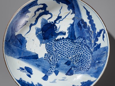 Lot 389 - A LARGE BLUE AND WHITE ‘QILIN’ DISH, TRANSITIONAL TO EARLY KANGXI PERIOD