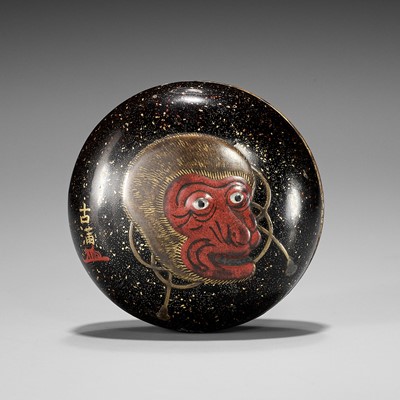 Lot 778 - KOMA: A LARGE LACQUER MANJU NETSUKE WITH SARU MASK