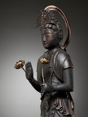 Lot 45 - A GILT AND LACQUERED WOOD FIGURE OF KANNON BOSATSU HOLDING LOTUS BLOSSOMS