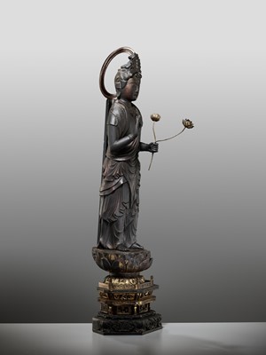 Lot 45 - A GILT AND LACQUERED WOOD FIGURE OF KANNON BOSATSU HOLDING LOTUS BLOSSOMS