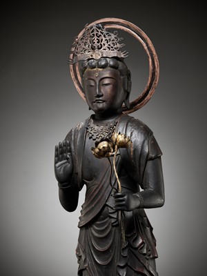 Lot 37 - A GILT AND LACQUERED WOOD FIGURE OF KANNON BOSATSU HOLDING LOTUS BLOSSOMS
