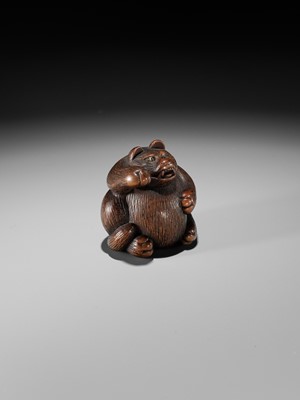 Lot 375 - MINKO: A WOOD NETSUKE OF TANUKI HARA NO