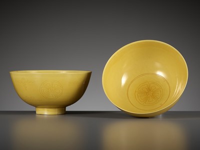 AN EXCEEDINGLY RARE PAIR OF INCISED YELLOW-GLAZED ‘FLORAL MEDALLION’ BOWLS, KANGXI MARKS AND PERIOD