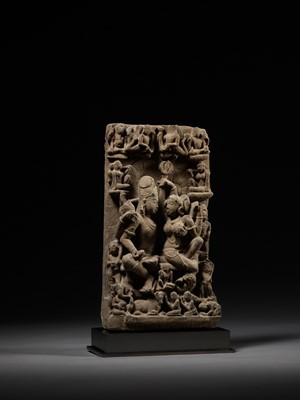 Lot 240 - A SANDSTONE STELE OF UMA MAHESHVARA, CENTRAL INDIA, 11TH-12TH CENTURY