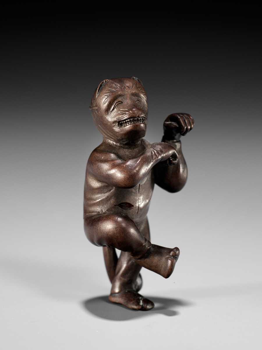 AN EXQUISITELY SMALL WOOD NETSUKE OF A FOX DANCER, ATTRIBUTED TO JUGYOKU