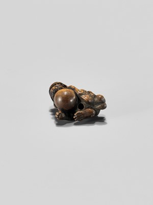 Lot 310 - A WOOD NETSUKE OF A SHISHI WITH BALL