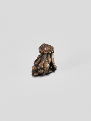 Lot 310 - A WOOD NETSUKE OF A SHISHI WITH BALL