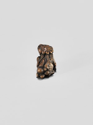 Lot 310 - A WOOD NETSUKE OF A SHISHI WITH BALL