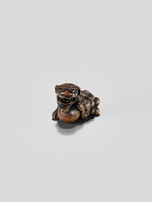 Lot 310 - A WOOD NETSUKE OF A SHISHI WITH BALL