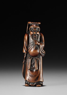 Lot 600 - AN EARLY WOOD NETSUKE OF KAN’U