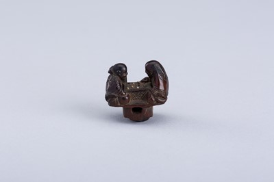 Lot 380 - INTERIOR OF A WOOD KARAKURI NETSUKE WITH TWO IMMORTALS PLAYING SUGOROKU, EDO PERIOD