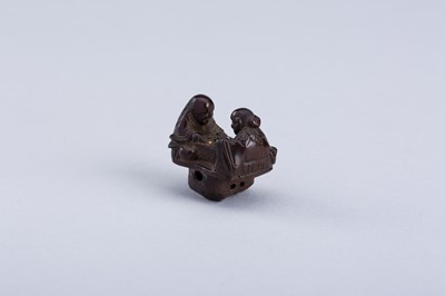 Lot 380 - INTERIOR OF A WOOD KARAKURI NETSUKE WITH TWO IMMORTALS PLAYING SUGOROKU, EDO PERIOD