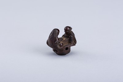 Lot 380 - INTERIOR OF A WOOD KARAKURI NETSUKE WITH TWO IMMORTALS PLAYING SUGOROKU, EDO PERIOD